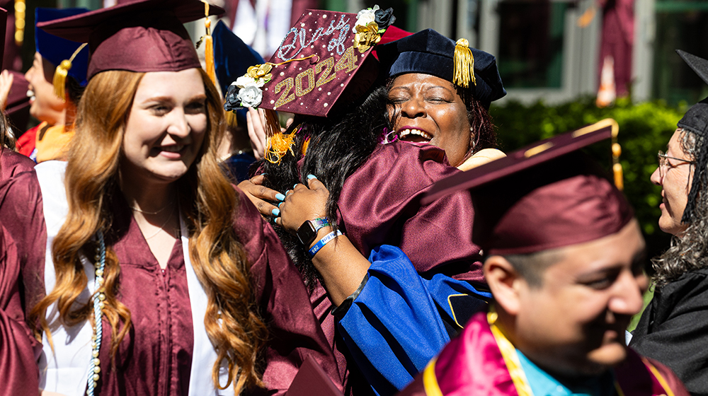 Graduates and faculty celebrate after Commencement 2024